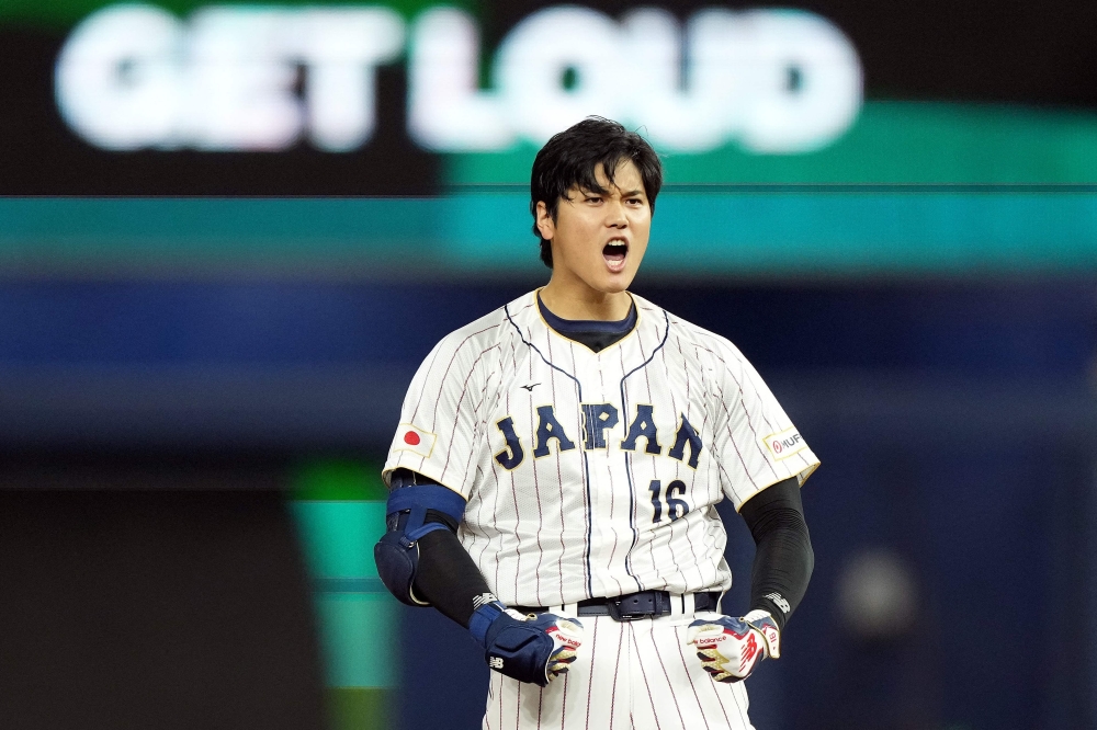 Shohei Ohtani #16 of Team Japan celebrates at second base after hitting a double in the ninth inning against Team Mexico during the World Baseball Classic Semifinals at loanDepot park on March 20, 2023 in Miami, Florida. Eric Espada/Getty Images/AFP