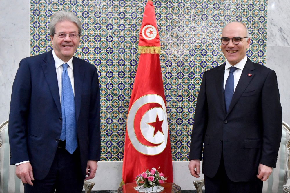 Tunisian Foreign Minister Nabil Ammar (right) welcomes European Commissioner for Economic Affairs Paolo Gentiloni in Tunis on March 27, 2023, to discuss reforms and possible financial assistance. (Photo by FETHI BELAID / AFP)
 