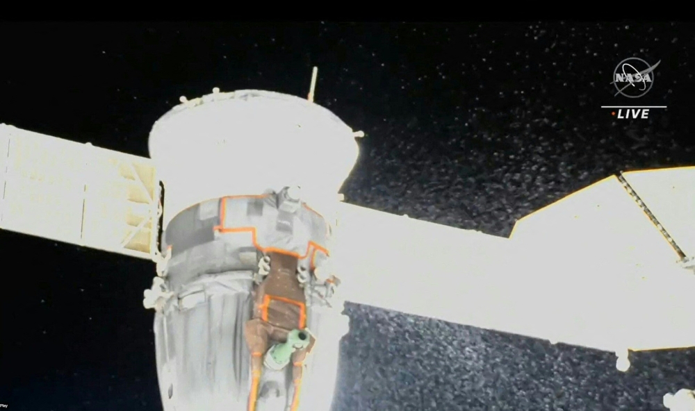 In this file photo taken on December 15, 2022 Video grab from a NASA feed obtained December 15, 2022 shows liquid spraying from the aft end of the Soyuz MS-22 spacecraft. Photo by HANDOUT / NASA / AFP