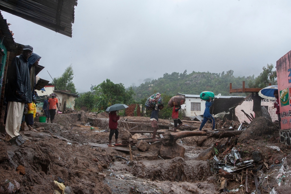 People repatriate residents and their property from a flood affected Chimwankhunda location in Blantyre on March 14, 2023 following heavy rains caused by cyclone Freddy. Photo by Amos Gumulira / AFP