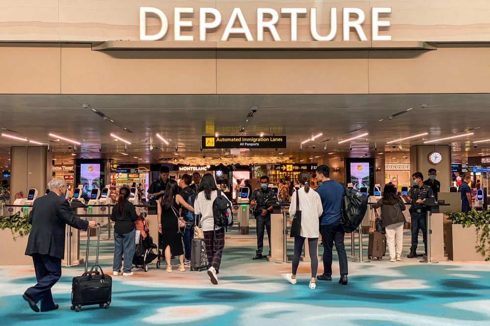 Trallers arrive at the departure hall in Singapore Changi airport in Singapore on March 31, 2023. Photo by Catherine Lai / AFP