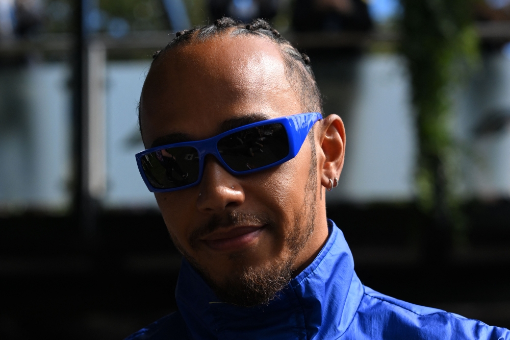 Mercedes' British driver Lewis Hamilton arrives ahead of the first practice session of the 2023 Formula One Australian Grand Prix at the Albert Park Circuit in Melbourne on March 31, 2023. (Photo by WILLIAM WEST / AFP)