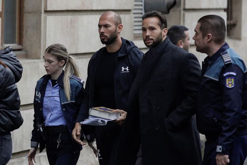 File photo: Andrew Tate and his brother Tristan are escorted by police officers outside the headquarters of the Bucharest Court of Appeal, in Bucharest, Romania, on January 10, 2023. Inquam Photos/Octav Ganea via REUTERS

