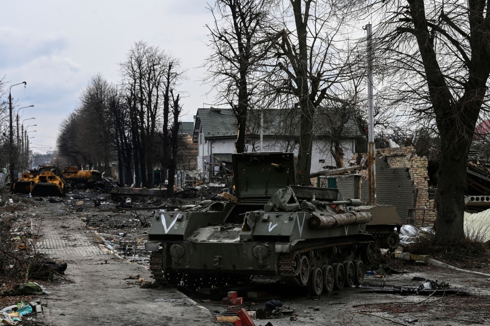 Destroyed Russian armored vehicles are pictured in the city of Bucha, west of Kyiv. (Photo by ARIS MESSINIS / AFP)
