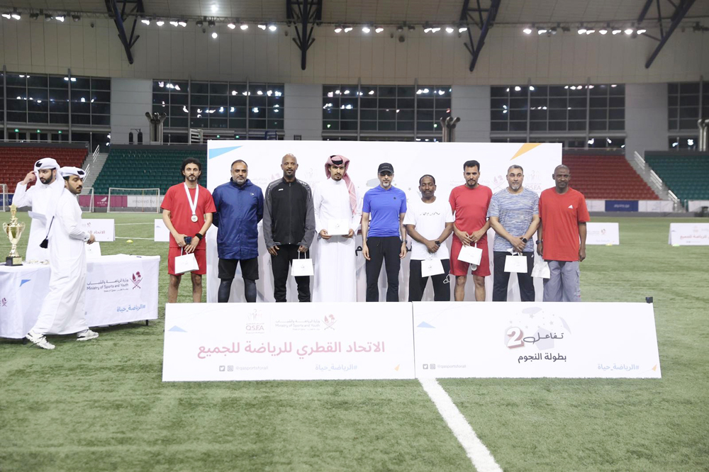 Minister of Sports and Youth H E Salah bin Ghanim Al Ali (centre) with players and referees after the final.