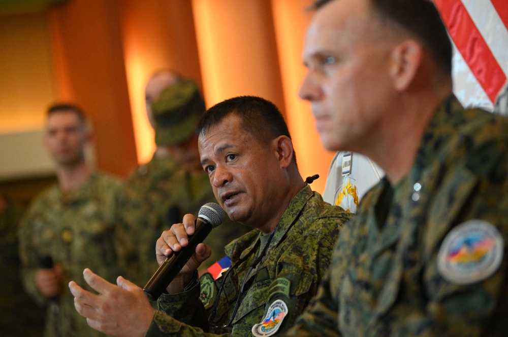 Philippines exercise director for Balikatan Major General Marvin Licudine (L) speaks while US exercise director and representative for Balikatan US marines Major General Eric Austin (R) listens during a press conference after the opening ceremony of the 'Balikatan' joint military exercise at the military headquarters in Quezon City, suburban Manila on April 11, 2023. (Photo by Ted ALJIBE / AFP)