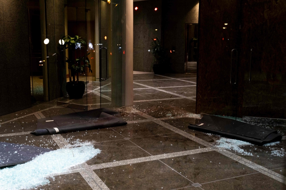 Broken glass remains on the floor at the Old National Bank on April 10, 2023 in Louisville, Kentucky. (Photo by Michael Swensen / Getty Images via AFP)