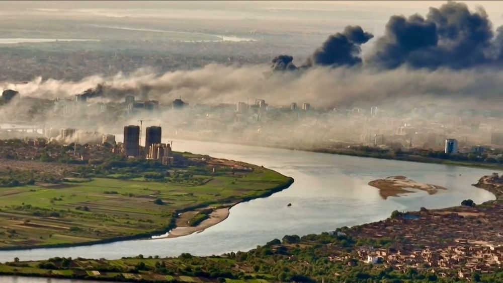 TOPSHOT - This video grab taken from AFPTV video footage on April 19, 2023, shows an aerial view of black smoke covering the sky above the capital Khartoum. (Photo by Abdelmoneim SAYED / AFP)