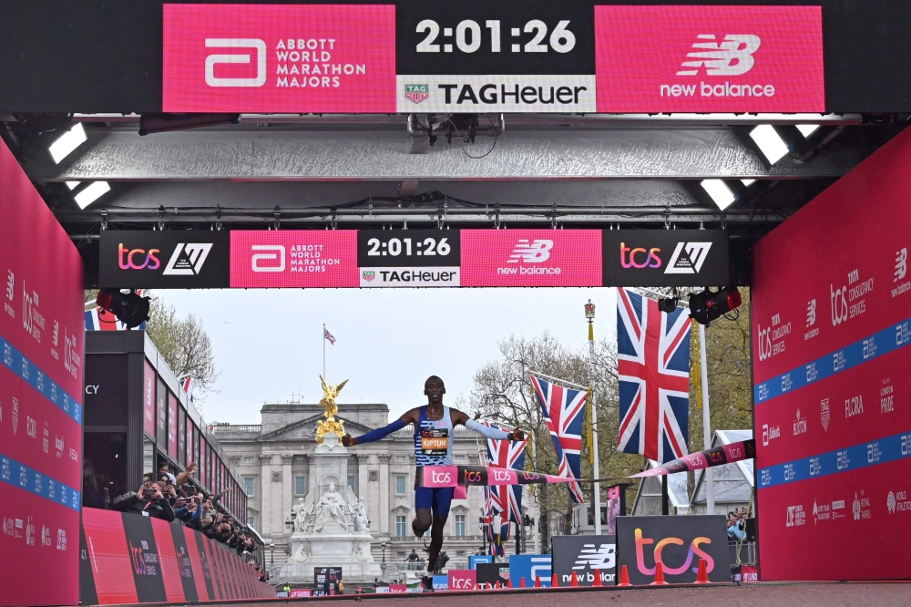 Kenya's Kelvin Kiptum breaks the tape to win the Men's race at the finish of the 2023 London Marathon in central London on April 23, 2023. Photo by JUSTIN TALLIS / AFP) 
