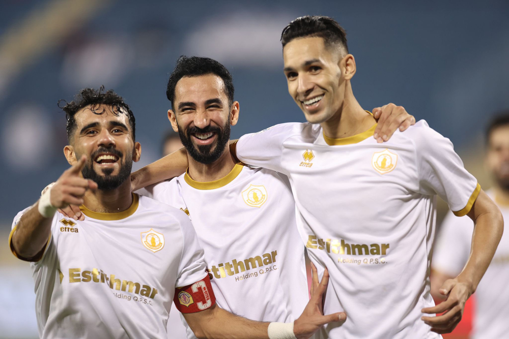Qatar SC players celebrate after wining the match.