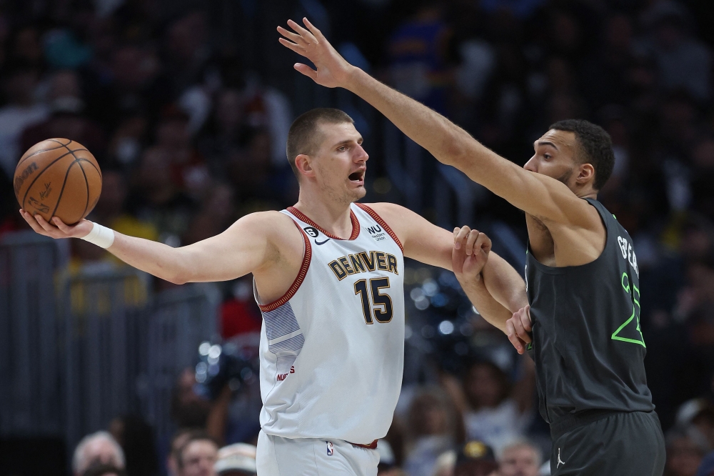 Nikola Jokic #15 of the Denver Nuggets is guarded by Rudy Gobert #27 of the Minnesota Timberwolves in the second quarter during Round 1 Game 5 of the NBA Playoffs at Ball Arena on April 25, 2023 in Denver, Colorado. Matthew Stockman/Getty Images/AFP 
