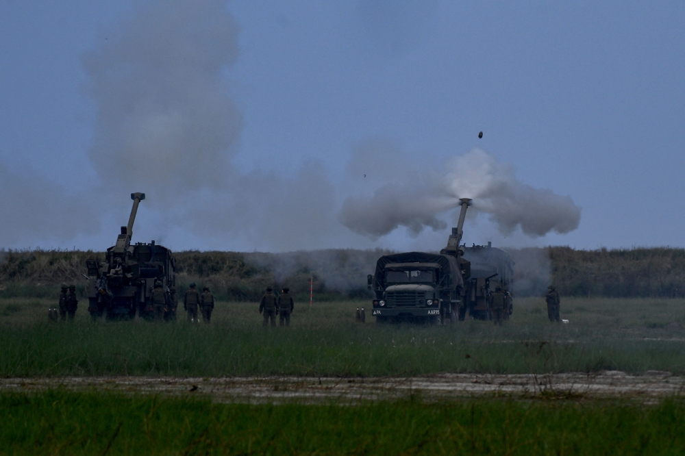 Philippine soldiers fire 155 mm Howitzers during a live fire exercise as part of the US-Philippines Balikatan joint exercise at the naval training base in San Antonio, Zambales province on April 26, 2023. (Photo by Ted ALJIBE / AFP)