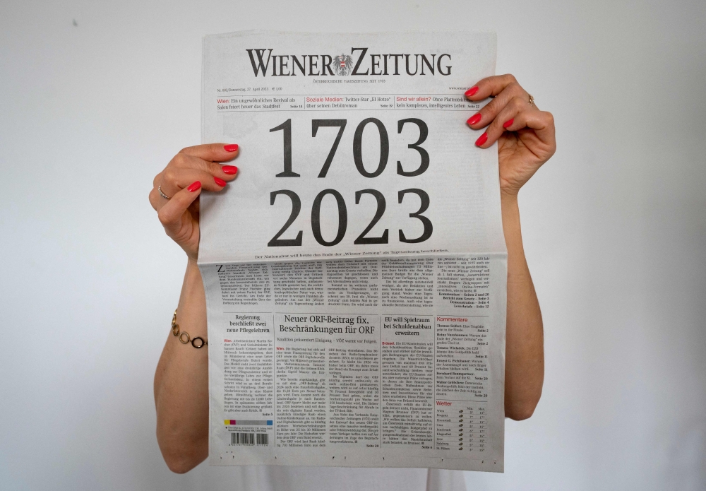 A woman holds the current issue of the 