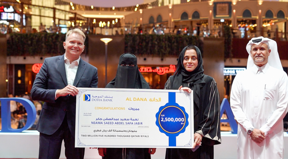 The winner of the grand prize with Doha Bank officials.