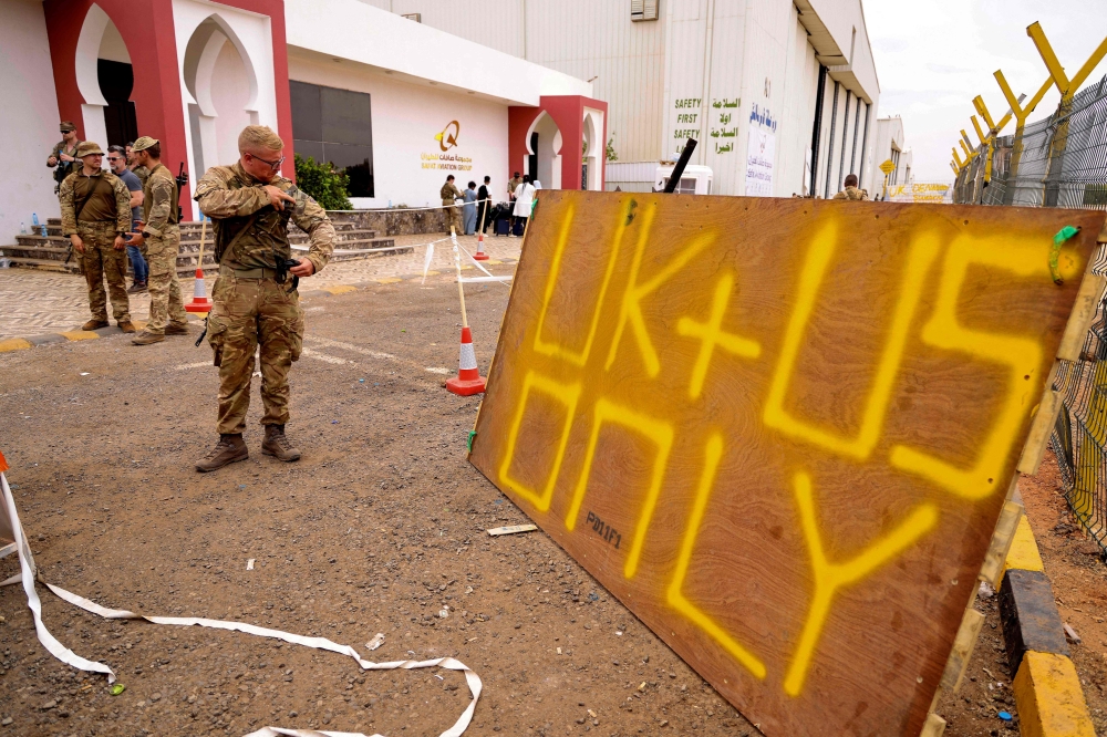 Military personnel during evacuations from Wadi Seidna Air Base, north of Khartoum in Sudan on April 30, 2023. (Photo by Arron Hoare / Royal Navy / AFP)