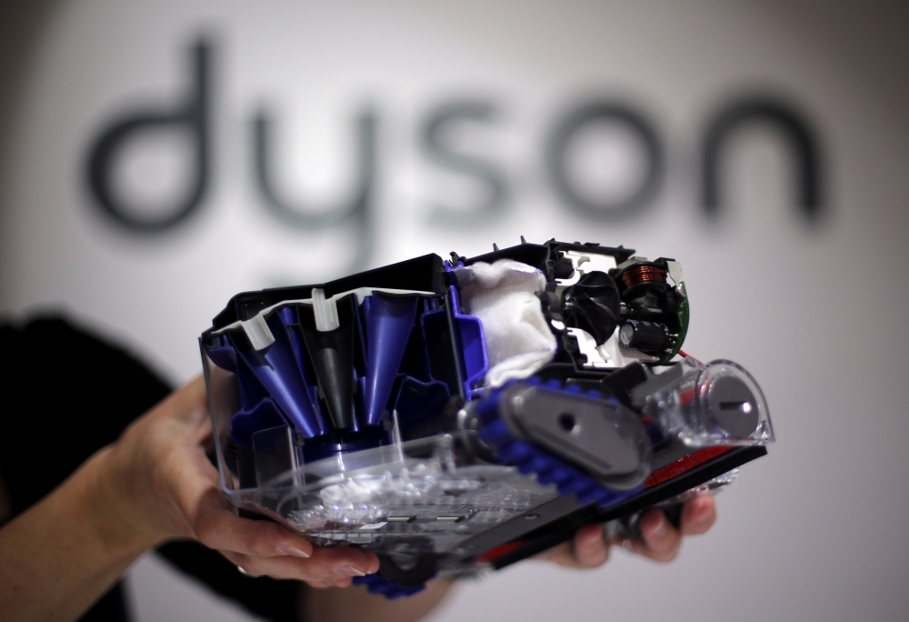 FILE PHOTO: A Dyson employee shows a Dyson 360 Eye robot vacuum cleaner without its cover during the IFA Electronics show in Berlin September 4, 2014. REUTERS/Hannibal Hanschke/File Photo

