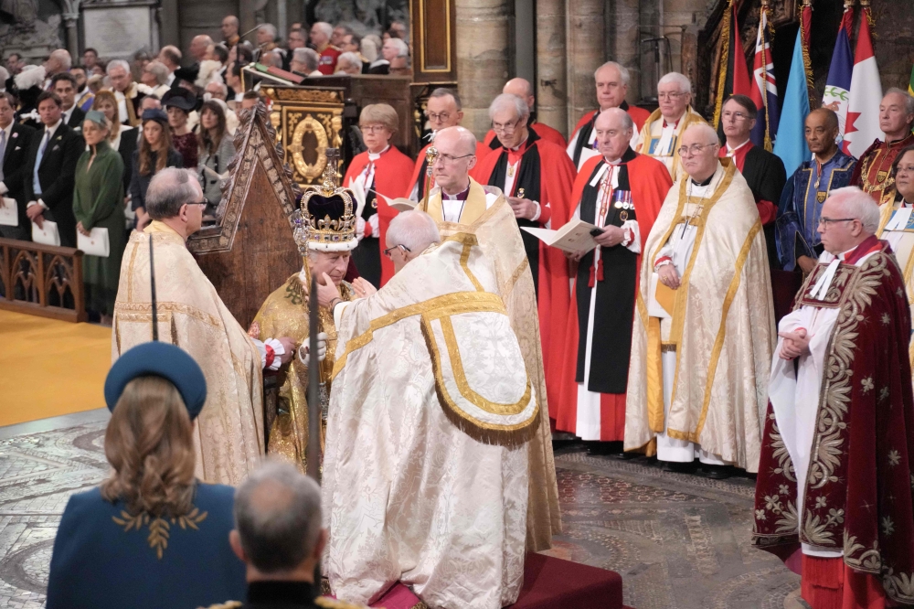 The Archbishop of Canterbury Justin Welby places the St Edward's Crown onto the head of Britain's King Charles III during the Coronation Ceremony inside Westminster Abbey in central London on May 6, 2023. Photo by Jonathan Brady / POOL / AFP
