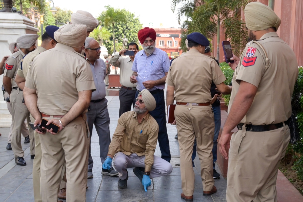 Punjab policemen inspect the site of a blast in Heritage Street near the Golden Temple in Amritsar on May 7, 2023. (Photo by Narinder NANU / AFP)