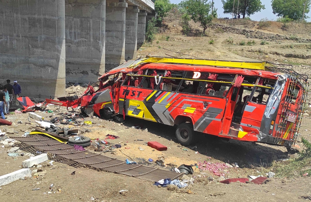 Onlookers gather at the site of a bus accident in Khargone district of India's Madhya Pradesh state on May 9, 2023. Photo by AFP
