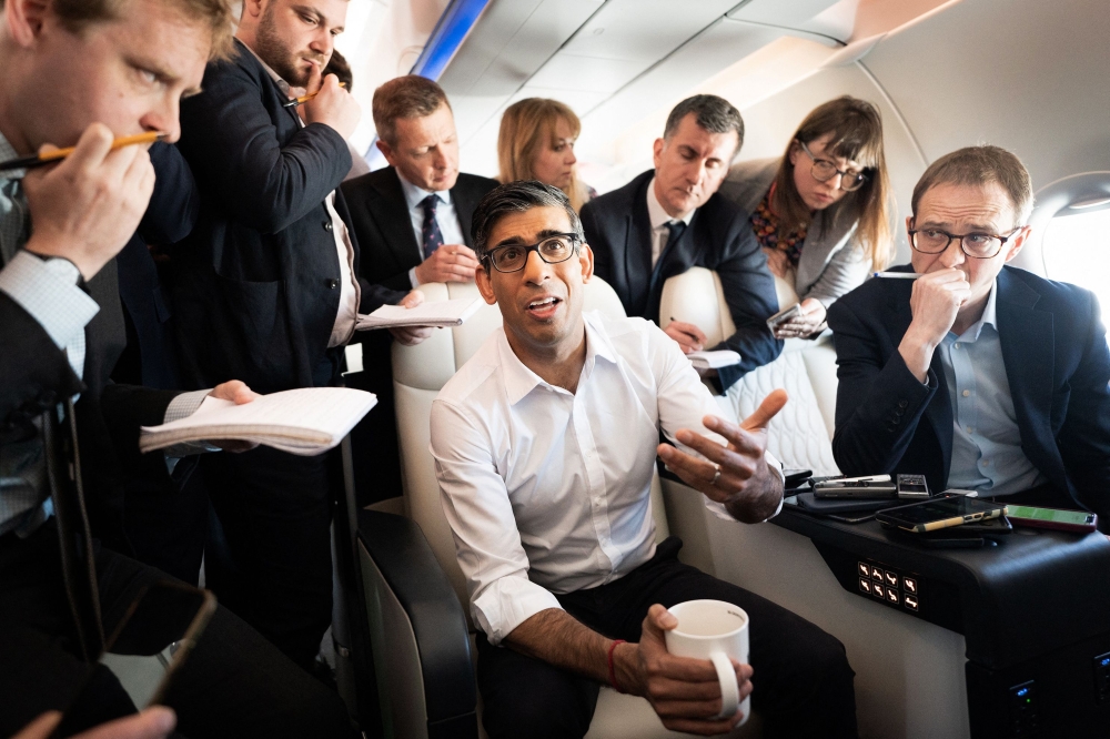 Britain's Prime Minister Rishi Sunak holds a huddle with political journalists on board of a government plane, as he heads to Japan to attend the G7 summit, in Hiroshima, on May 17, 2023. (Photo by Stefan Rousseau / POOL / AFP)
