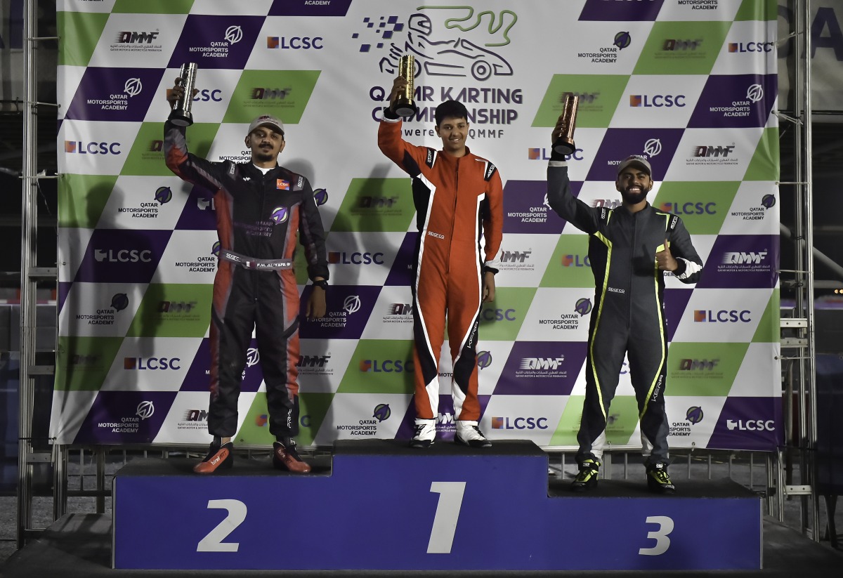 The 2023 Qatar Karting Championship winner Bader Al Sulaiti celebrates on the podium along with Faesal Al Yafei and Omar Aswat.  
Final 