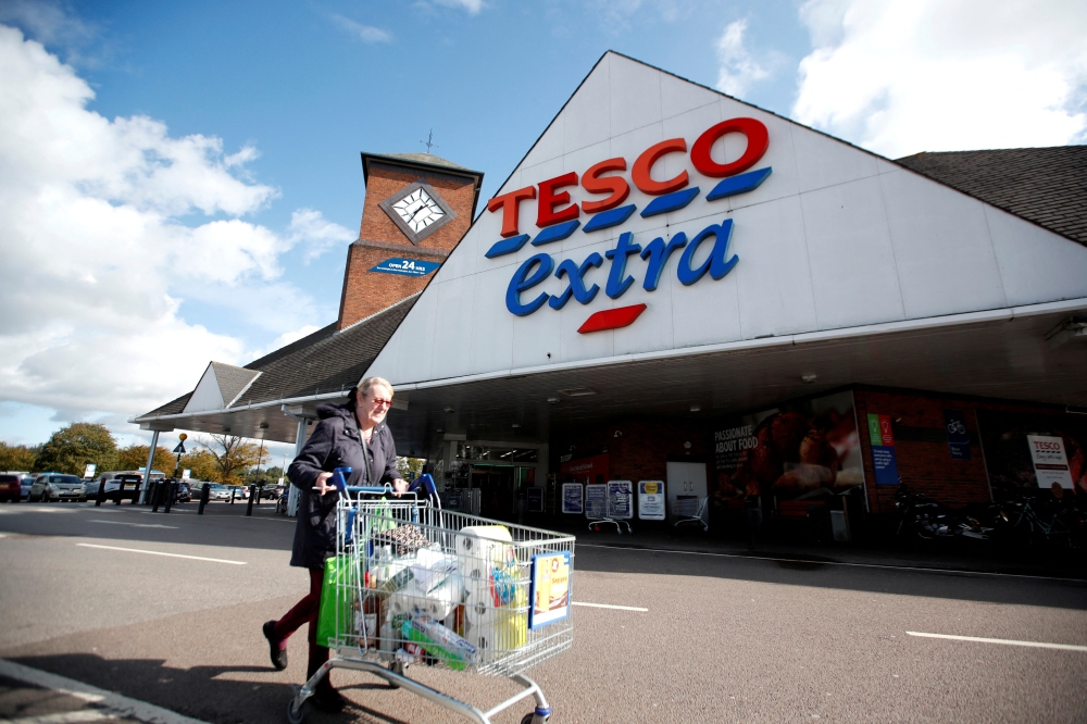 File Photo: A woman walks past a Tesco supermarket in Hatfield, Britain October 6, 2020. (Reuters /Peter Cziborra)