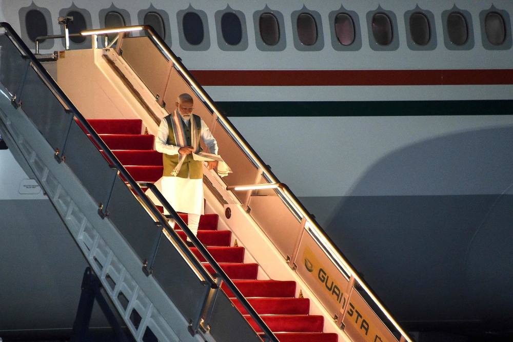 India's Prime Minister Narendra Modi disembarks from the plane at Port Moresby International Airport on May 21, 2023, ahead of the Forum for India Pacific Islands Cooperation (FIPIC) Summit in Papua New Guinea. (Photo by Andrew Kutan / AFP)