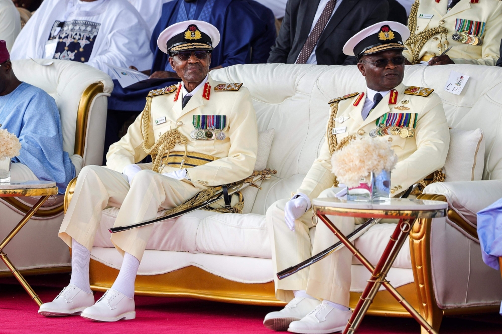 Outgoing Nigerian President Muhammadu Buhari (left) looks on with the Chief of Naval Staff, Vice Admiral Awwal Zubairu Gambo at the presidential fleet review held at the Naval Dockyard in Lagos on May 22, 2023. (Photo by Samuel Alabi / AFP)