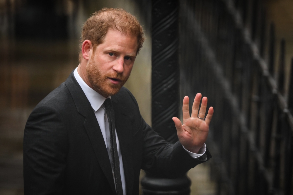 Britain's Prince Harry, Duke of Sussex waves as he arrives at the Royal Courts of Justice, Britain's High Court, in central London on March 28, 2023. Photo by Daniel Leal / AFP

