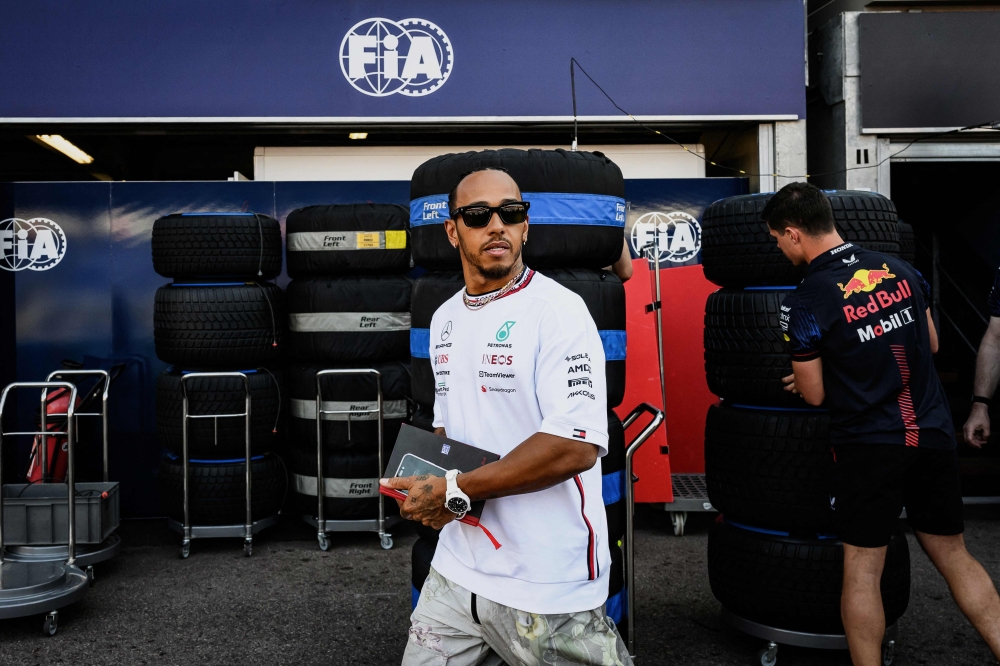 TOPSHOT - Mercedes' British driver Lewis Hamilton walks in the pit lane ahead of the Monaco Formula One Grand Prix at the Monaco street circuit in Monaco on May 25, 2023. (Photo by JEFF PACHOUD / AFP)