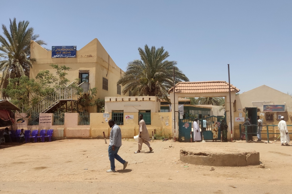 Sudanese walk outside Bashir hospital in southern Khartoum on May 26, 2023 as fighting eased in Sudan following a ceasefire. (Photo by AFP)