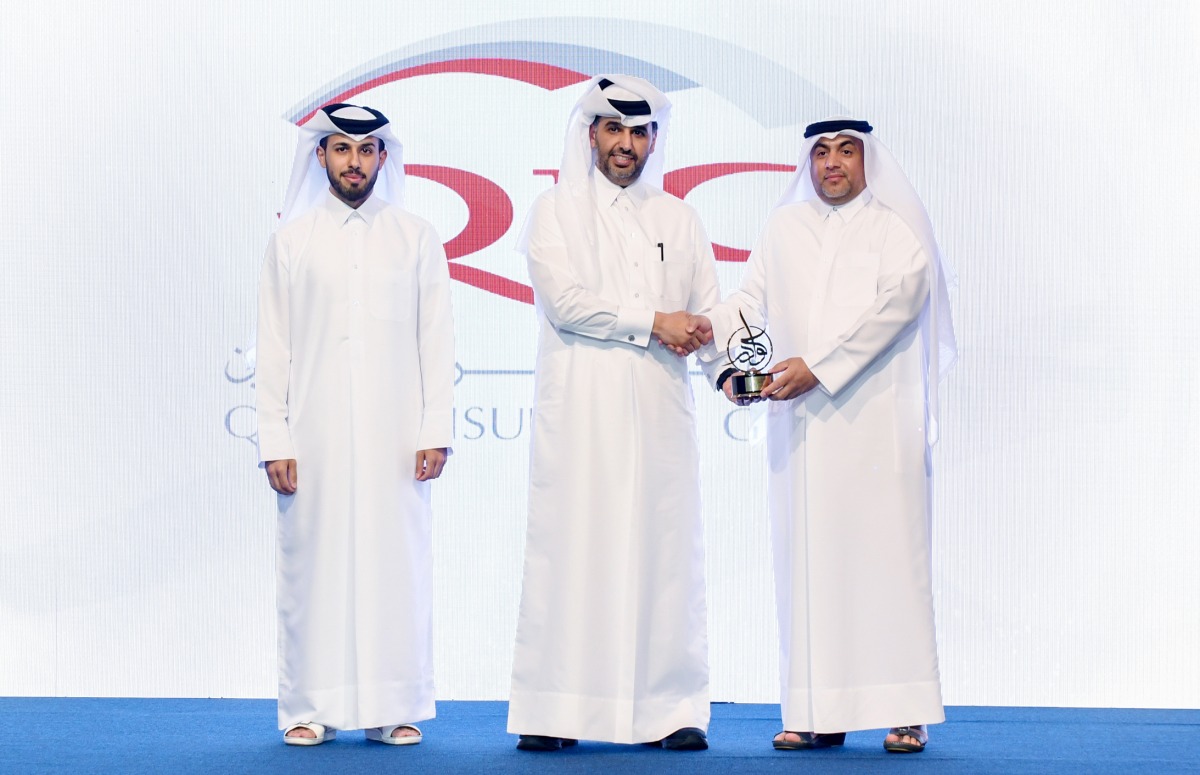 QIC Group Chief Administrative Officer Rashid Al Buainain  (right) receiving the award.