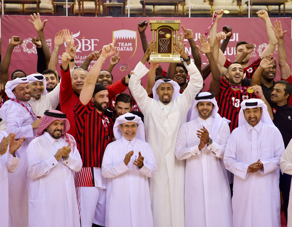 Al Rayyan players and officials celebrate after receiving the League trophy from Qatar Basketball Association President Mohammed Saad Al Mughaiseeb following their win over Al Shamal, on Saturday.