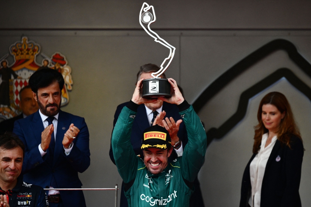 Second-placed Aston Martin's Spanish driver Fernando Alonso holds up his trophy on the podium after the Formula One Monaco Grand Prix at the Monaco street circuit in Monaco, on May 28, 2023. Photo by Jeff PACHOUD / AFP