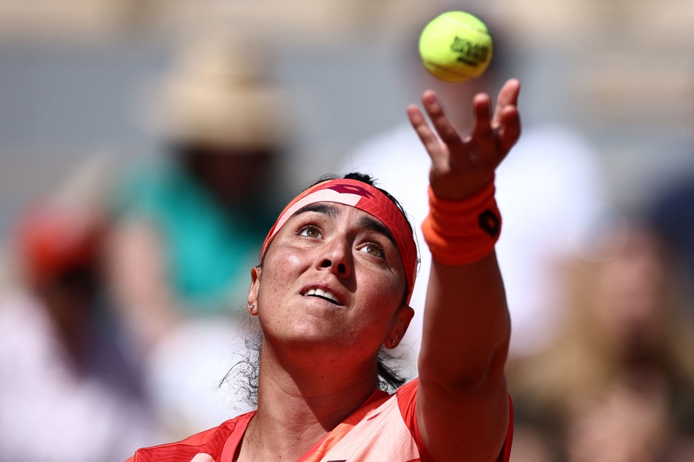 Tunisia's Ons Jabeur serves to Italy's Lucia Bronzetti during their women's singles match on day three of the Roland-Garros Open tennis tournament at the Court Philippe-Chatrier in Paris on May 30, 2023. (Photo by Anne-Christine POUJOULAT / AFP)