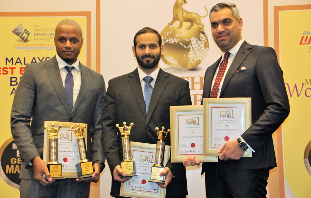 UDC officials pose with four Golden Globe Tigers Awards.