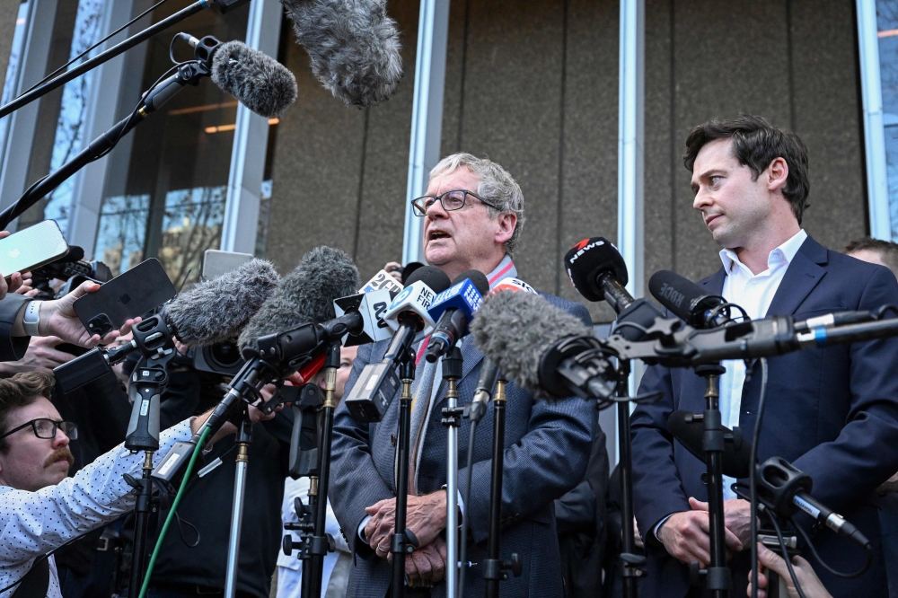 Journalists Chris Masters (L) and Nick McKenzie (R) talk to the media outside the Federal Court of Australia in Sydney on June 1, 2023. (Photo by SAEED KHAN / AFP)