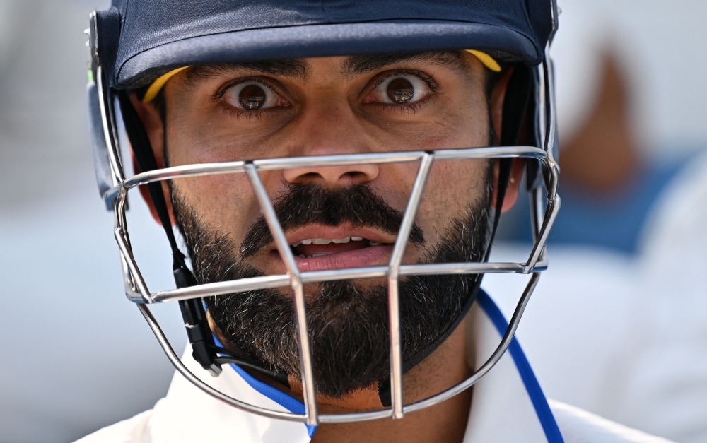 India's Virat Kohli prepares to walk out to bat ahead of play on day 5 of the ICC World Test Championship cricket final match between Australia and India at The Oval, in London, on June 11, 2023. (Photo by Glyn Kirk / AFP)