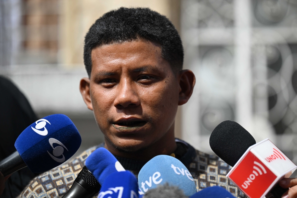 Indigenous Manuel Ranoque, father of the four Indigenous children who were found alive after being lost for 40 days in the Colombian Amazon rainforest following a plane crash, speaks with the press before arriving at the Military Hospital, where the children were hospitalized, in Bogota on June 11, 2023. (Photo by Raul Arboleda / AFP) 
