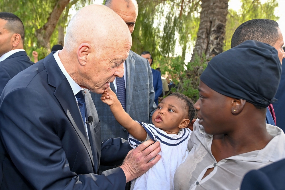 A handout picture provided by the Tunisian Presidency Press Service on June 10, 2023, shows President Kais Saied speaking with migrants from sub-Saharan African countries during a visit to Sfax. (Photo by Tunisian Presidency / AFP)