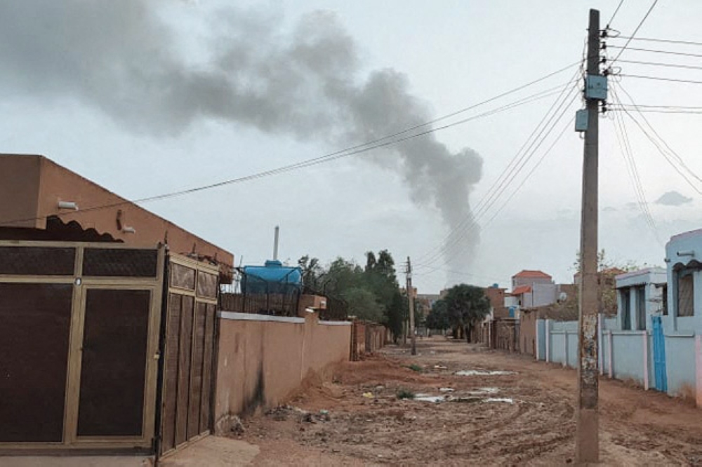 Smoke billows in the distance amid ongoing fighting in Khartoum on June 13, 2023. (Photo by AFP)