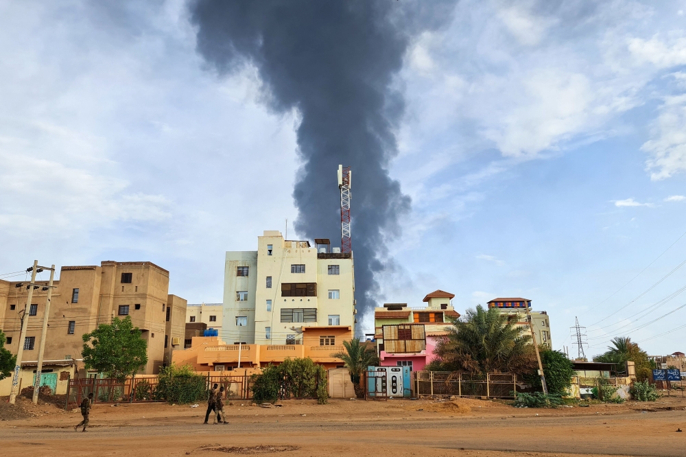 AFP file photo: Black smoke billows behind buildings amid ongoing fighting in Khartoum on June 9, 2023. 