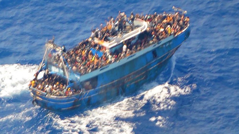 This image released by The Hellenic Coastguard on June 14, 2023, shows an aerial view taken from a rescue helicopter, of migrants onboard a fishing vessel in the waters off the Peloponnese coast of Greece on June 13, 2023. (Photo by Hellenic Coastguard / AFP)