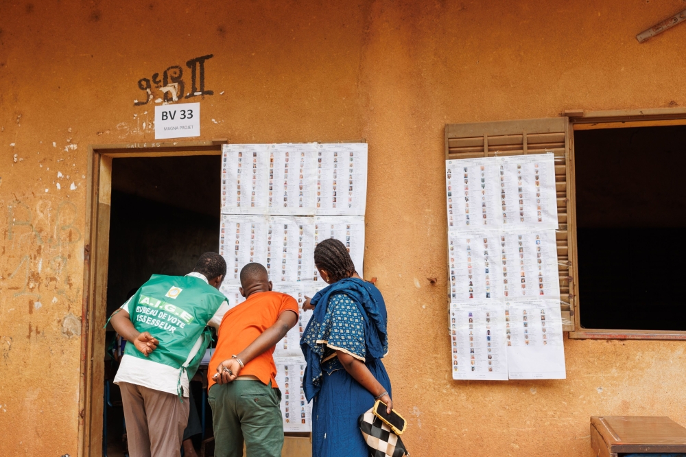 Voters look for their names on the voters roll at a polling station in Bamako on June 18, 2023 ahead of Mali's referendum vote. (Photo by OUSMANE MAKAVELI / AFP)
