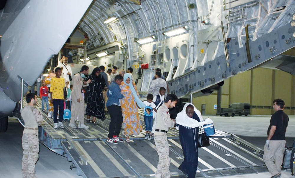 Evacuees alight from a Qatari airplane from Sudan as part of Qatar's air bridge support for the Sudanese people.