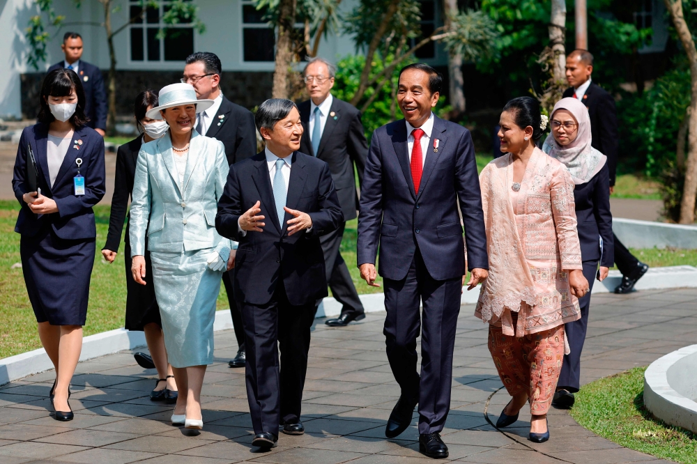 Japan's Emperor Naruhito (3rd L) and Empress Masako (2nd L) visit the Bogor Botanical with Indonesian President Joko Widodo (3rd R) and First Lady Iriana Widodo (2nd R) in Bogor on June 19, 2023. (Photo by WILLY KURNIAWAN / POOL / AFP)
