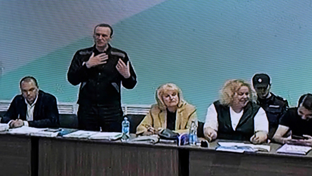 Russian opposition leader Alexei Navalny (2nd left) is seen on a screen during court hearings in the IK-6 penal colony at Melekhovo, about 250 kilometres (155 miles) east of Moscow, where he is jailed on June 19, 2023. (Photo by Natalia Kolesnikova / AFP)

