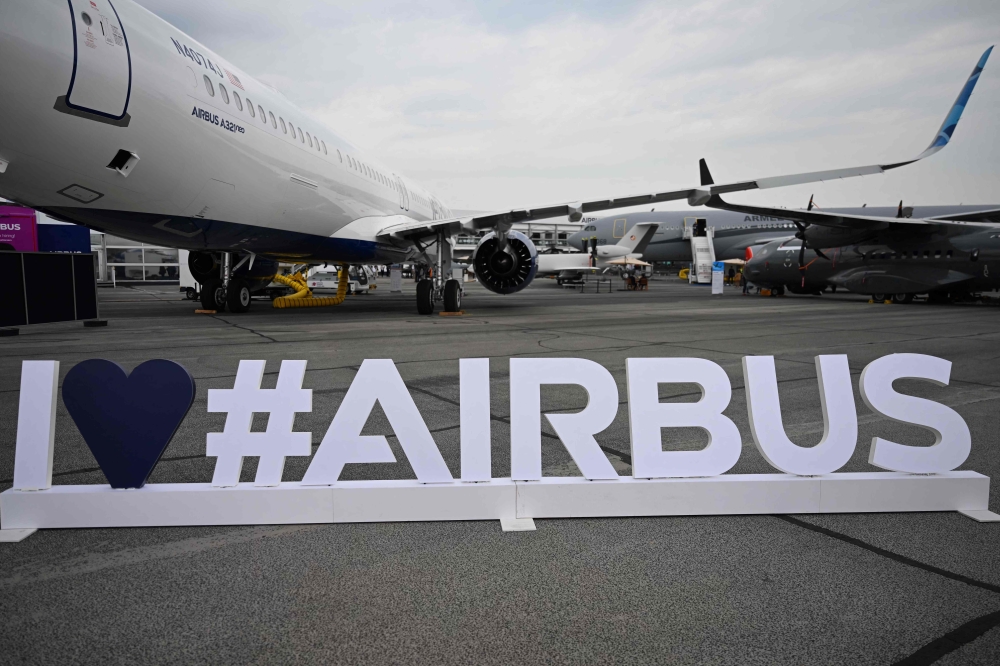 This photograph taken on June 19, 2023 shows an Airbus sign during the International Paris Air Show at the Paris Bourget Airport. (Photo by Emmanuel Dunand / AFP)