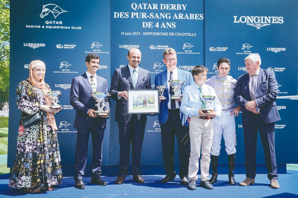 The connection of Al Ghadeer with officials during the presentation ceremony after the Al Shaqab Racing owned four-year-old Arabian won the Gr.1 (PA) Qatar Derby des Pur Sang Arabes de 4ans, at Chantilly, France. DOWN: Christophe Soumillon guides Al Ghadeer to win.
