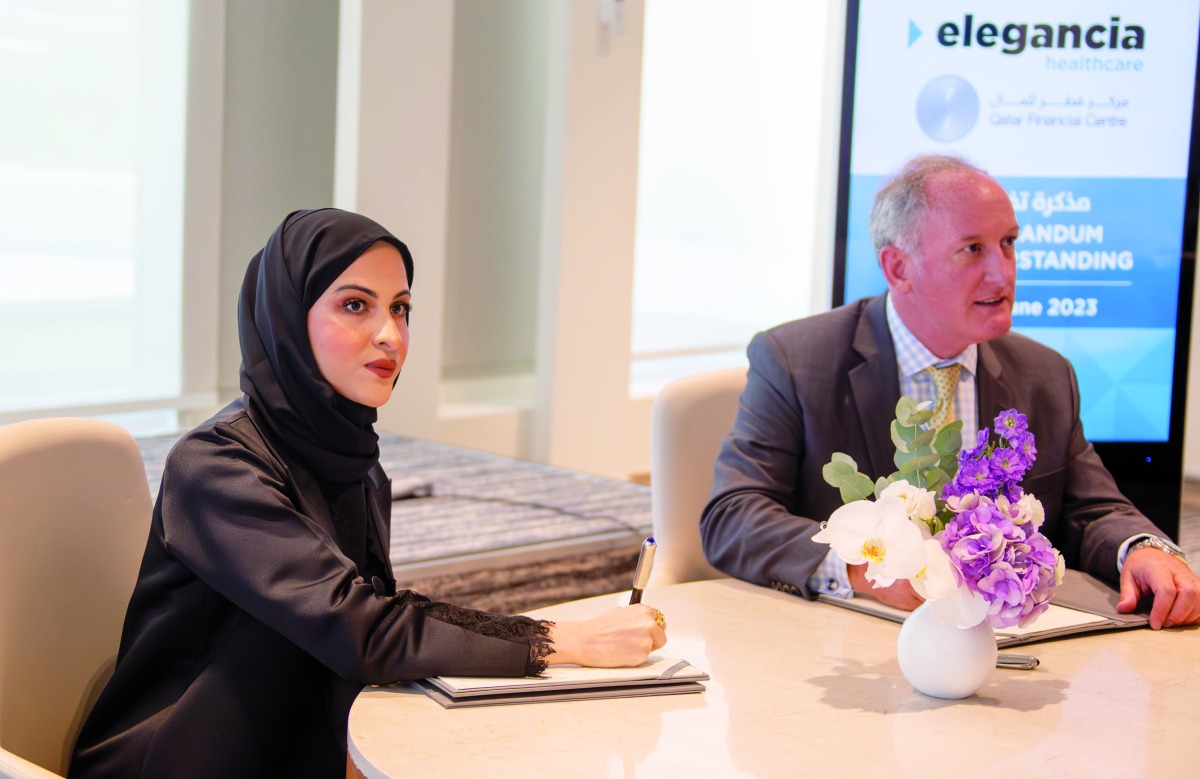 QFC, Elegancia Healthcare officials during the signing ceremony.